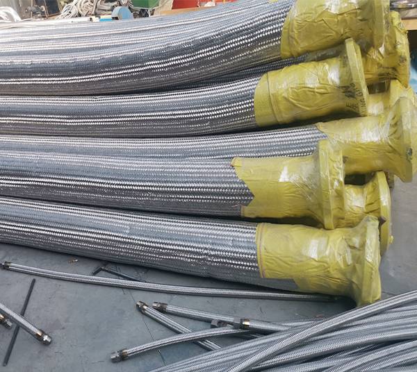 Many metal hoses are placed on the ground.